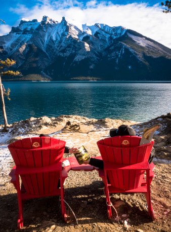 devour-cao-ab-landmark-banff-lake-minnewanka-with-red-chairs-sharing-jerky-3-edited